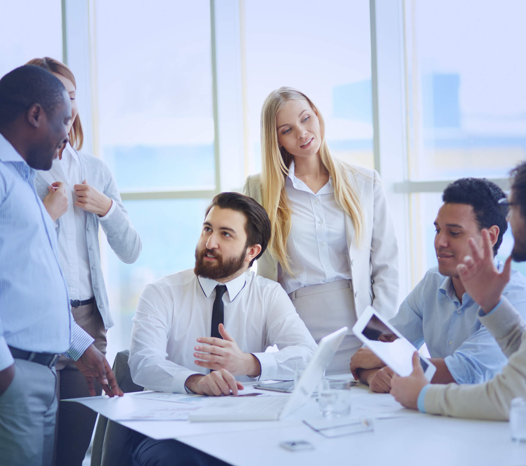 A group of business people sitting around a table.