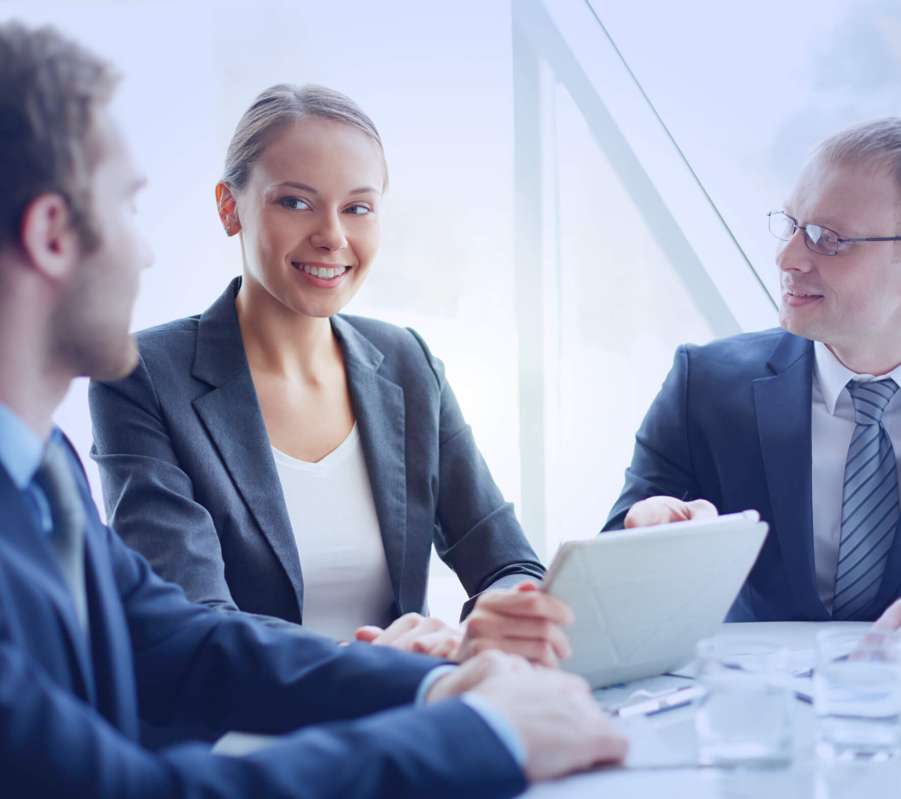 A group of business people sitting around a table.